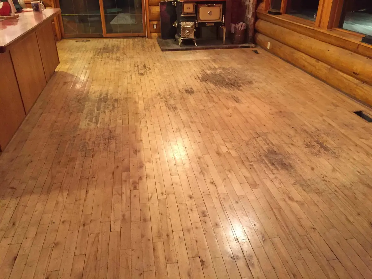 Cabin floor marked and worn before refinishing