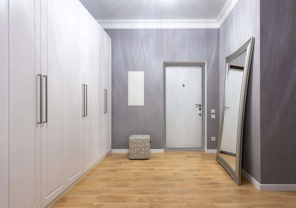 An entryway with light oak flooring